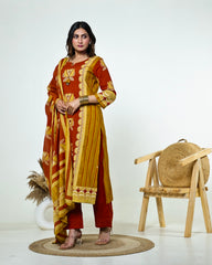 Navya-Rust Cotton Suit Set with Mustard Lotus Print, Mirror Work, Handwork Neckline & Tasselled Dupatta