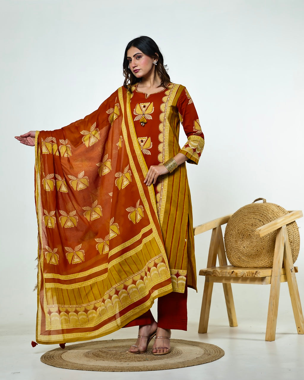 Navya-Rust Cotton Suit Set with Mustard Lotus Print, Mirror Work, Handwork Neckline & Tasselled Dupatta