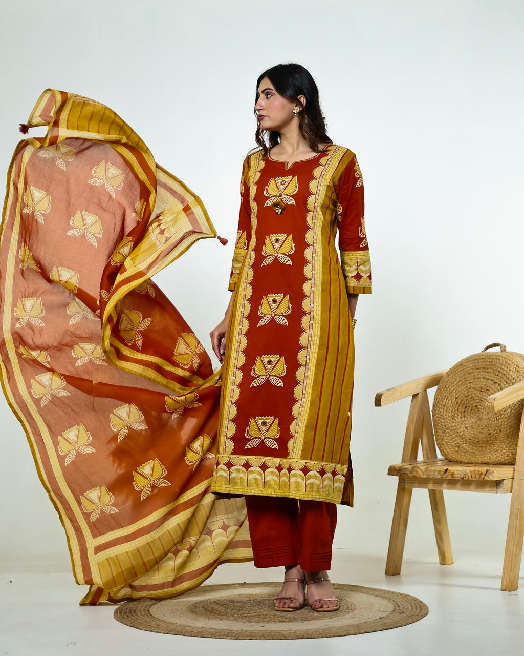 Navya-Rust Cotton Suit Set with Mustard Lotus Print, Mirror Work, Handwork Neckline & Tasselled Dupatta