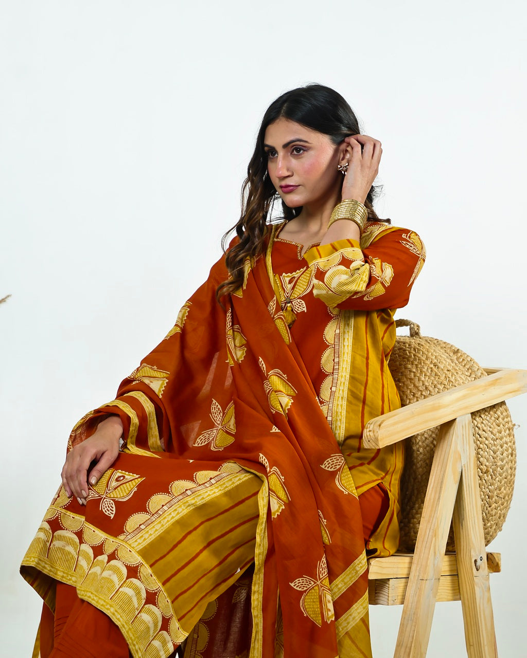 Navya-Rust Cotton Suit Set with Mustard Lotus Print, Mirror Work, Handwork Neckline & Tasselled Dupatta