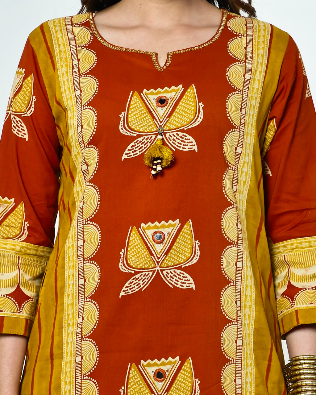 Navya-Rust Cotton Suit Set with Mustard Lotus Print, Mirror Work, Handwork Neckline & Tasselled Dupatta