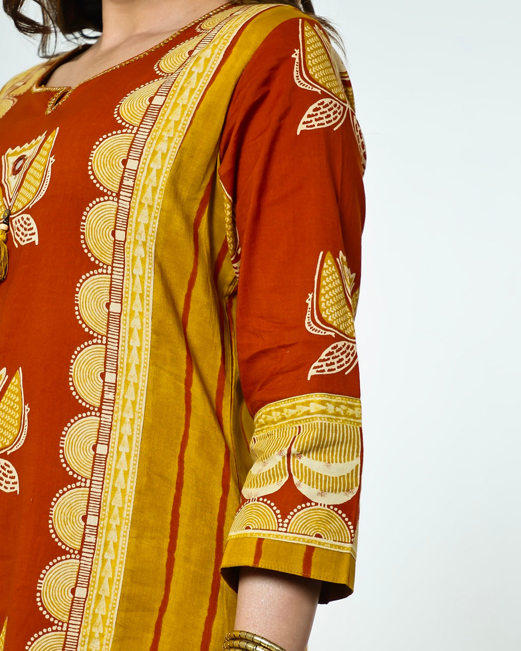 Navya-Rust Cotton Suit Set with Mustard Lotus Print, Mirror Work, Handwork Neckline & Tasselled Dupatta